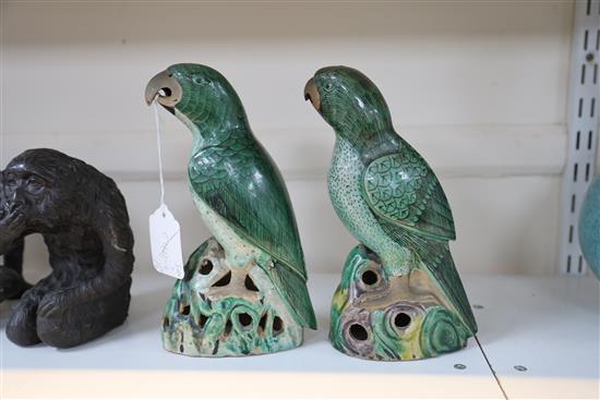 Two similar Chinese enamelled biscuit figures of parrots, Kangxi period, H. 21cm and 21.5cm